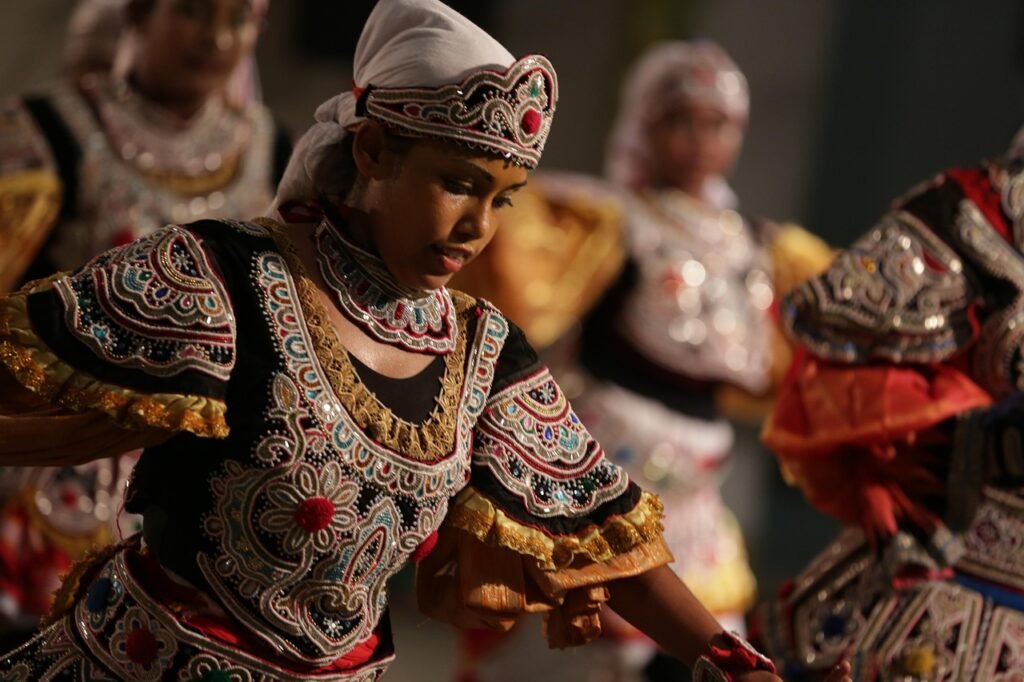 Traditional Sri Lankan dancers performing a cultural dance in colourful costumes