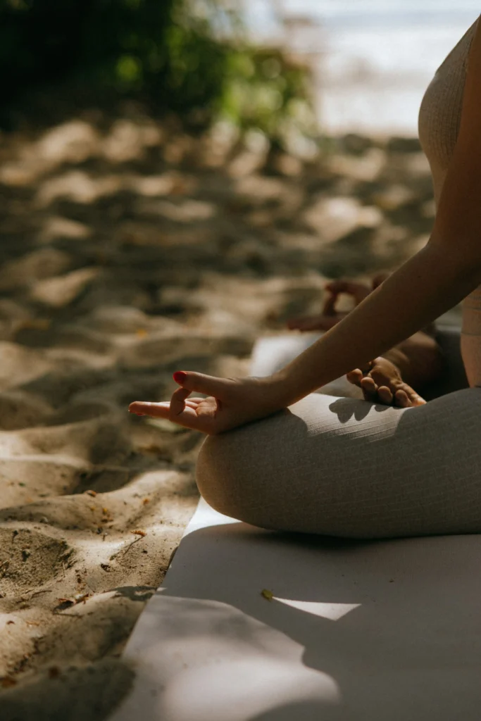 Person meditating peacefully in a tranquil natural setting in Sri Lanka